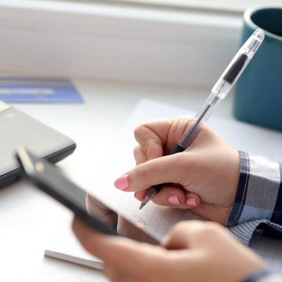 Woman with notebook and a phone